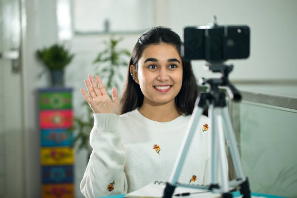 istock Girl vlogging or video chatting using mobile phone at home 1298610838