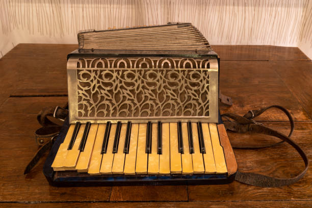 istock A vintage accordion standing on a wooden table 1298611625