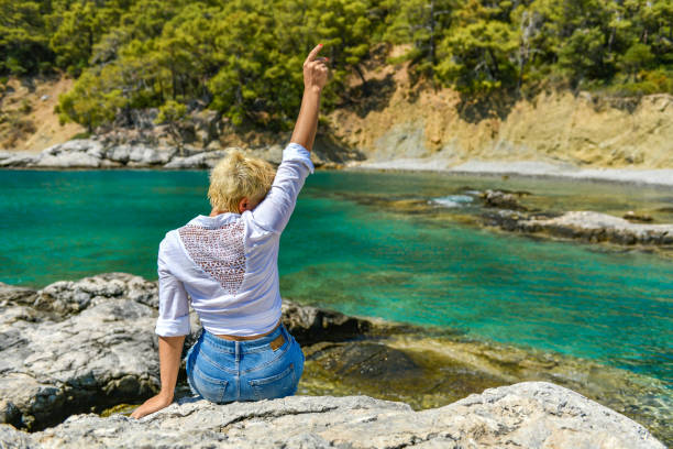 A young woman on the cliffs in the sea.