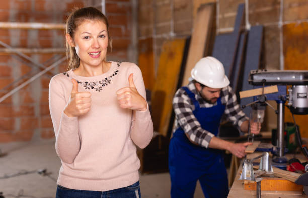 istock Architect with drawing checks the work of builders 1298611969