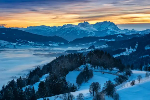 awesome winter landscape at sunset with  view from the Allgau Alps over the Bregenzer Wald in Austria to Mount Saentis in Switzerland