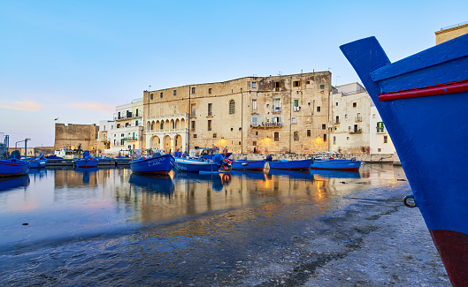 Monopoli, Puglia Italy - June 21, 2019 Waterfront with small wooden rowboats.