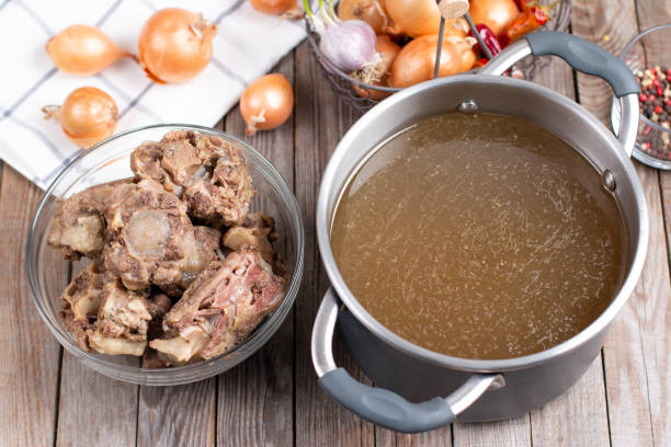 istock Bone Broth Bouillon in Metal saucepan on the table, paleo diet 1298613262