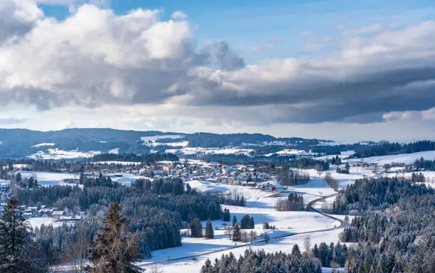 winter landscape in the lower western Allgaeu Alps with the village of Oberreute
