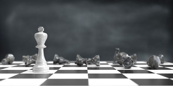 Business strategy, winning, teamwork and competition concept. 3d rendered white King chess piece standing alone on chess board. Dark atmosphere and large copy space.