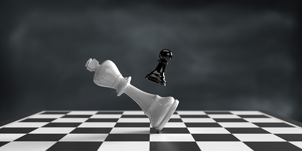 Business strategy, winning, teamwork and competition concept. 3d rendered chess pieces, single black pawn defeats white king on chess board. Dark atmosphere and large copy space.