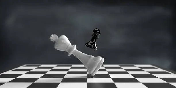 Photo of Pawn defeats King on chess board.