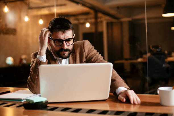 istock Businessman sitting at office desk working on new project. 1298615214