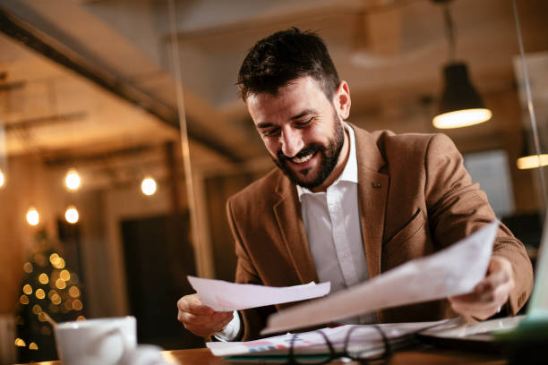 istock Businessman sitting at office desk working on new project. 1298615321