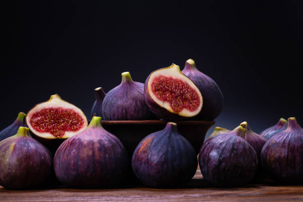 istock Tasty figs on a black background. Top view. 1298616238