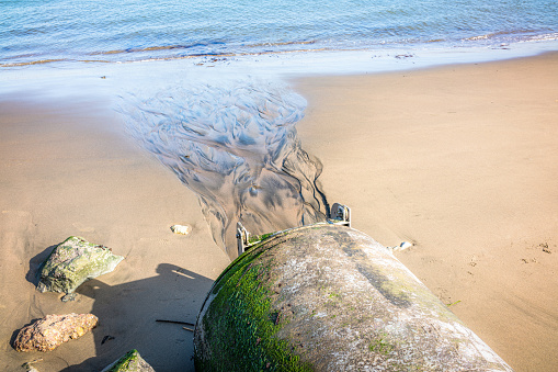 Arromanches les Bains beach with the remains of the Mulberry harbour in Normandy France Europe