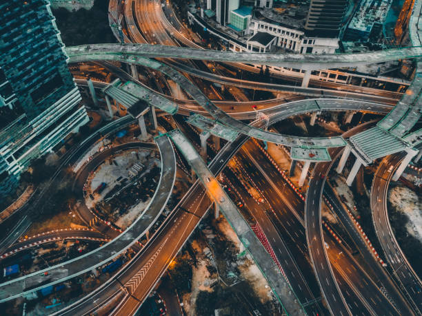 drone view directly above night scene city with elevated road bridges cross junction