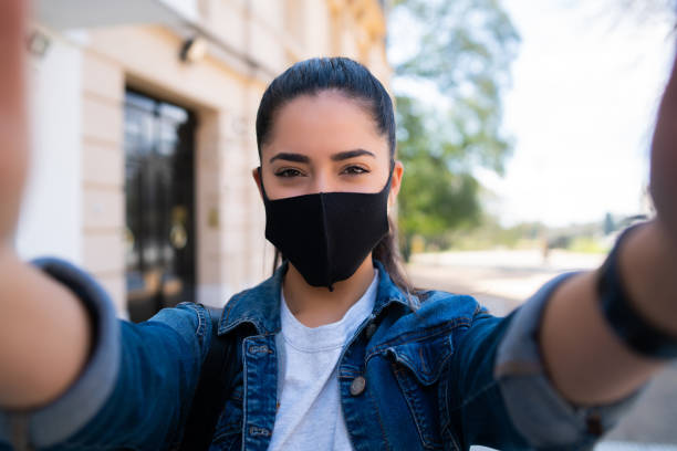 istock Young woman taking selfies outdoors. 1298618525