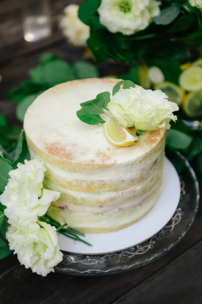 istock cake with lemons, lime cake,wedding yellow cake. white with yellow cake, decorated with fresh flowers 1298618774