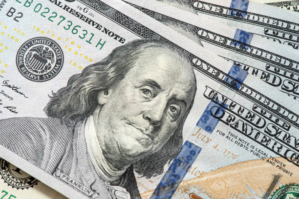 istock Close up of new hundred dollar banknotes. 1298619679