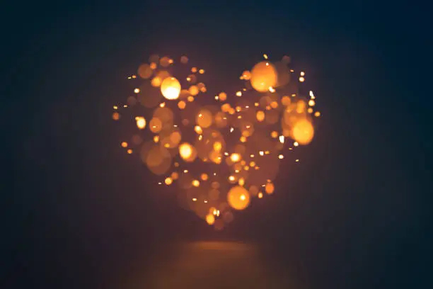 Photo of Shining bokeh heart on dark background