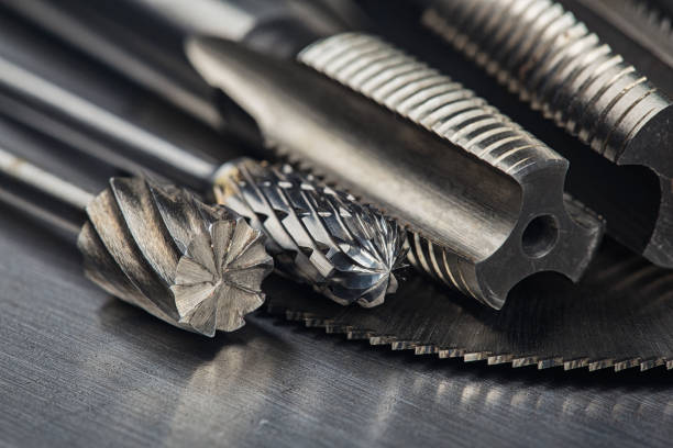 istock set of different drill bits,thread tap and mill cutters with caliper ruler on steel plate background. Locksmithing deal. 1298621662