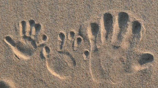 A barefoot foorprint on a sunny warm sandy beach