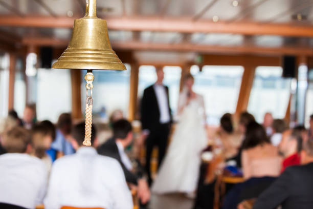 Traditional ship bell made of brass on a boat at a free wedding ceremony in summer
