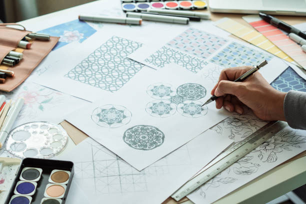 istock Designer designing drawing sketch pattern geometric flower seamless wallpaper fabric textile fashion industry. artistic design studio. 1298623520