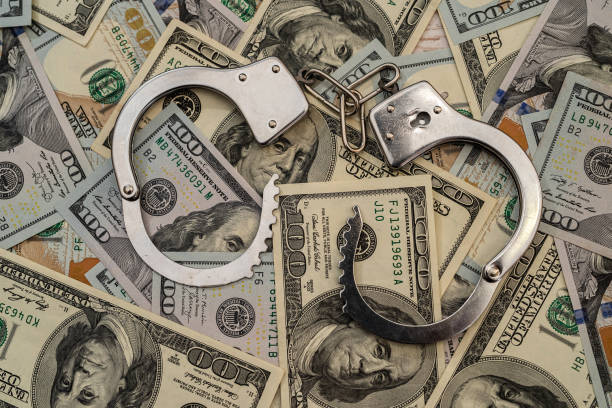 istock handcuffs on  american hundred dollar bills 1298623889