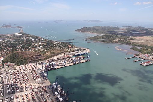 entrance to the panama canal through the pacific ocean passing the bridge of the americas and cargo port
