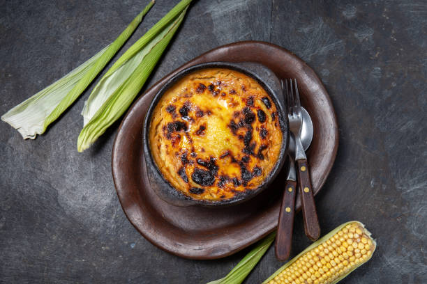 istock Chilean food. Traditional Pastel de Choclo corn pie. Beef meat with onion, chicken and egg covered with ground corn in clay bowl, top view 1298624832