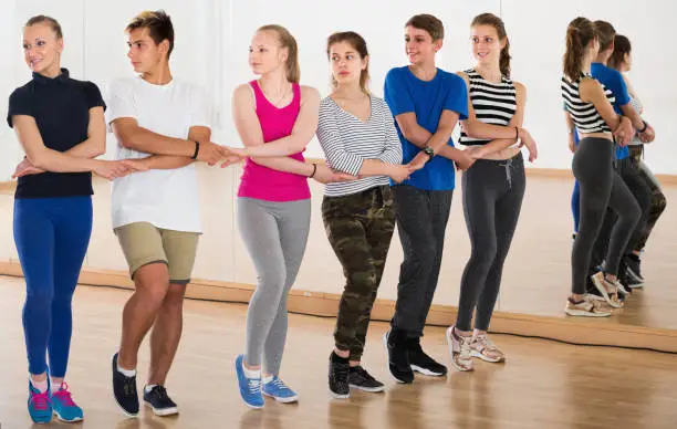 Photo of Teenagers dancing folk dance  in studio smiling