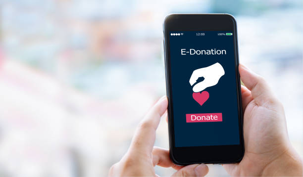 e-donation concept. close-up of man hands make an online donate via mobile phone charitable foundation stock pictures, royalty-free photos & images