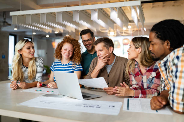 istock Creative brainstorming. Happy business people, designers, architects working as a team in office 1298626969