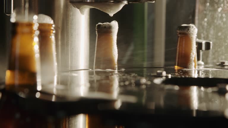 Beer bottles on automated machine during capping process