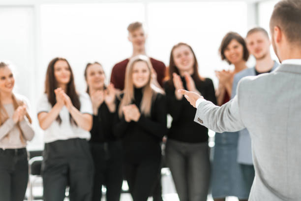 istock blurry image of a group of different people standing in a conference room 1298628868