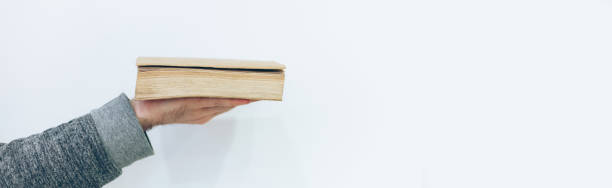 Man holding close old paper book