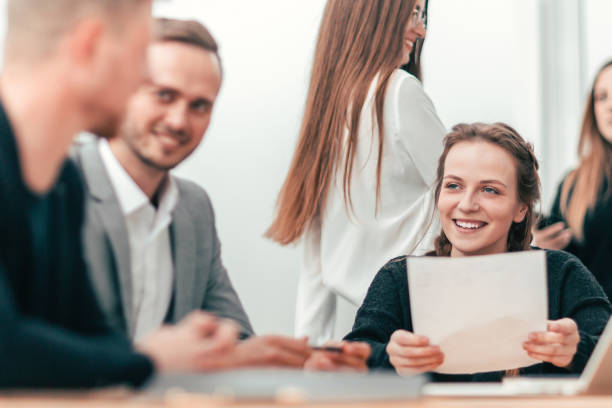 istock group of young employees discussing working papers 1298629338