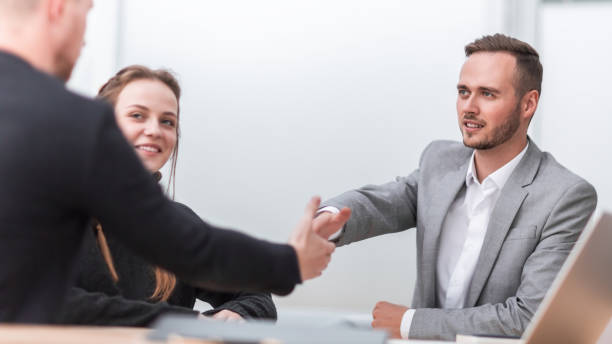 istock business people greeting each other with a handshake 1298629389