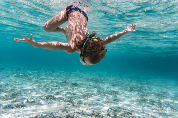 istock Boy dives into the sea 1298630709