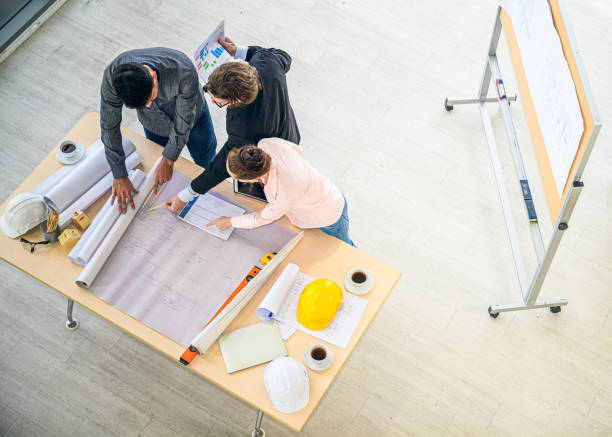 istock Top view of Caucasian engineer group teamwork meeting for planning project on the table with paperwork. 1298630719