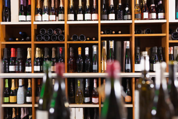 istock Racks with red and white wine bottles in shop 1298635103