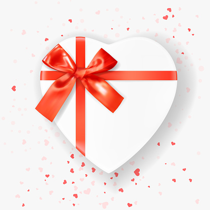 Heart shaped white Gift Box tied with Red Ribbons with a Bow on white background with heart shaped confetti. Top view. Greeting Card Template. Heart decoration. Love and Holiday concept. 3D Vector