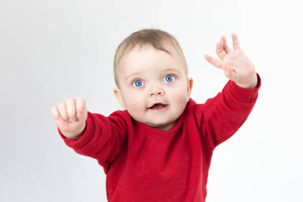 istock Beautiful kid pulls his hands up to his parents, white background 1298637319
