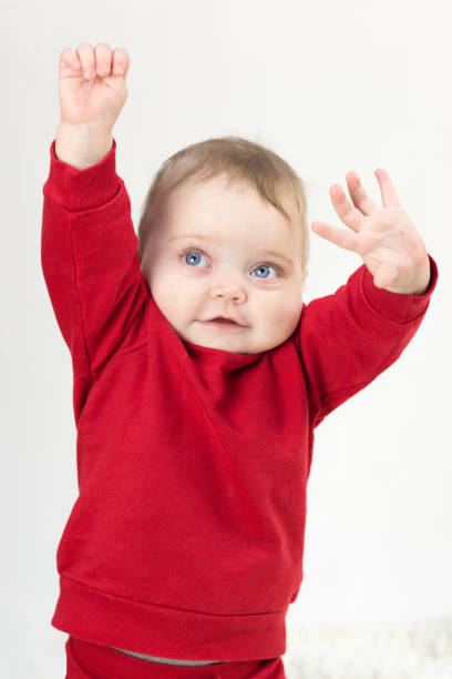 istock Beautiful kid pulls his hands up to his parents, white background 1298637345