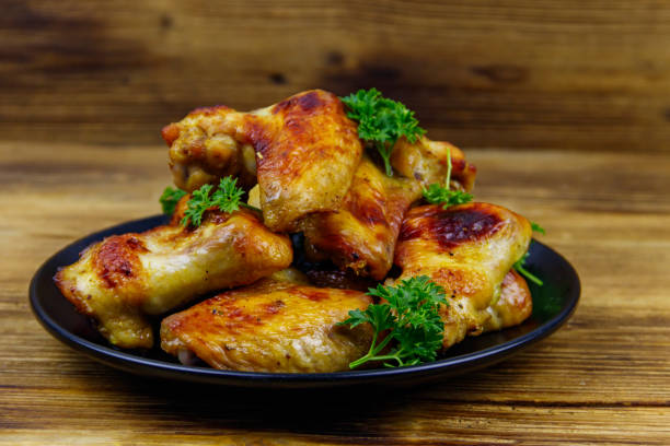 istock Baked chicken wings on a wooden table 1298638349