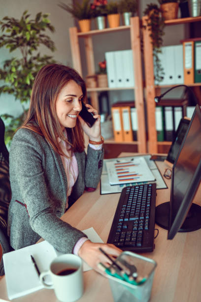 istock Female Working In Office And Using Smartphone 1298638495