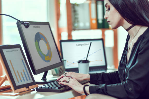 istock Female In Dark Attire Working In Office Environment And Drinking Takeaway Coffee 1298638576