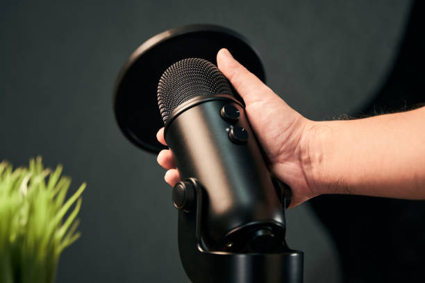 istock male hand holding a professional microphone 1298640507