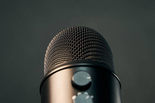 istock close up view of a black professional microphone on gray background 1298641305