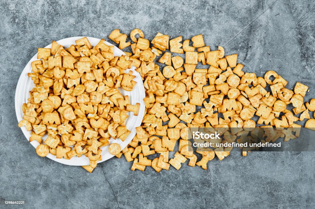 Square Letters Cracker Scattered Alphabet Crackers On A White Plate And On A Marble Background ...