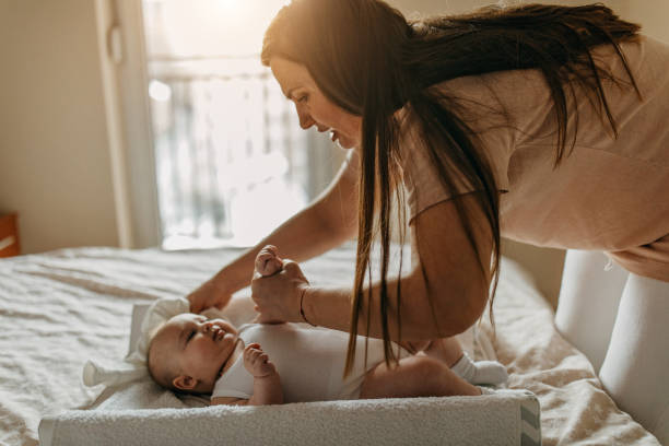 istock Mommy changing diapers 1298644262