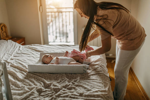 istock Mommy changing diapers 1298644460