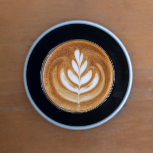 istock Top view hot coffee cappuccino latte art flower shape in ceramic cup selective focus 1298646297